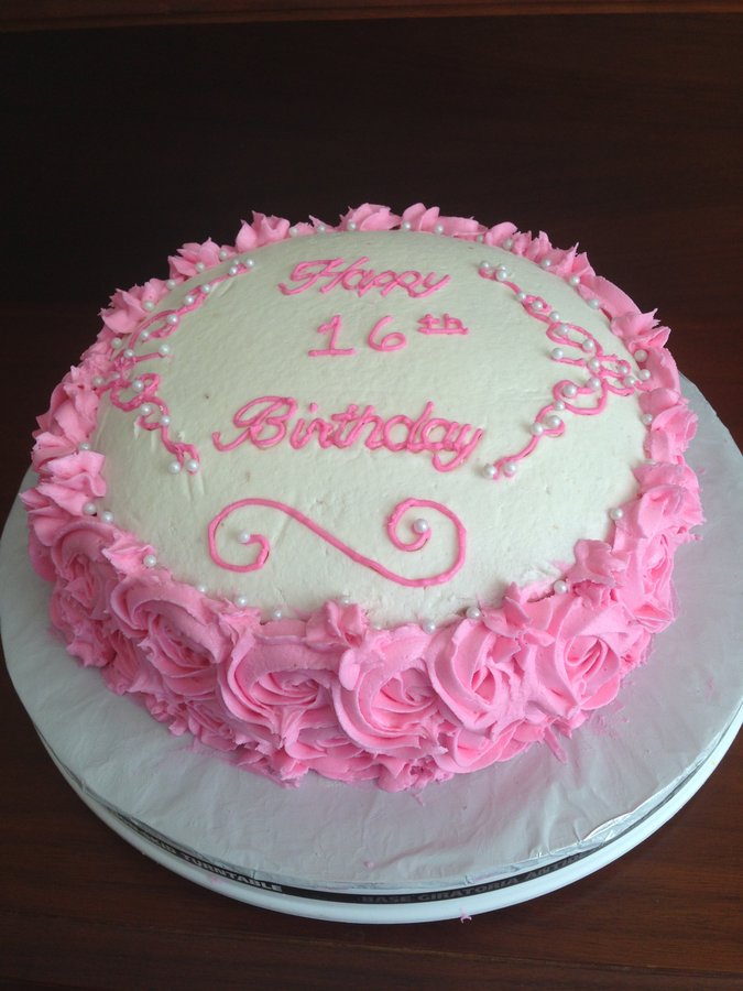 Round Happy 16th Birthday cake with pink buttercream rosettes around the sides